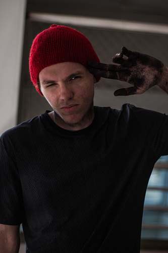 people man wearing black crew-neck t-shirt pointing his head human