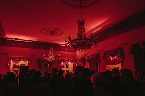 human people sitting on table near black and white chandelier lamp