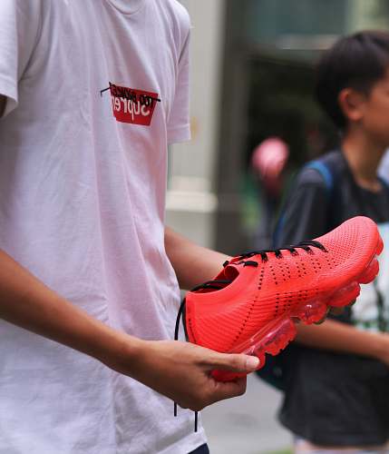human person holding red shoe people