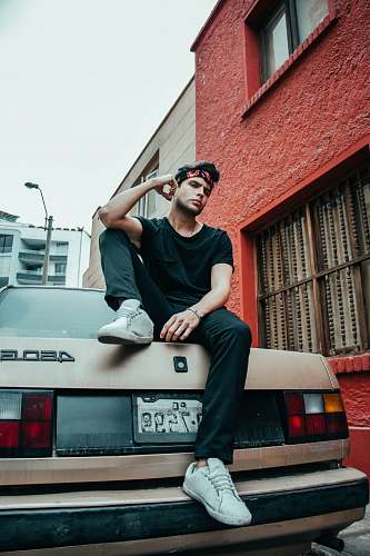 human person sitting on brown car people