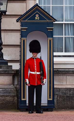 military Royal Guard standing near post military uniform