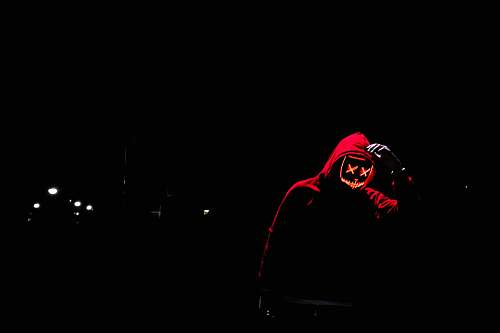 red silhouette of person at night time mask