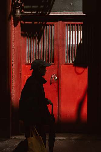 human silhouette of person walking in front of door people