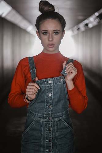 human woman holding her dungaree dress denim