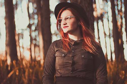 human woman in black jacket trees