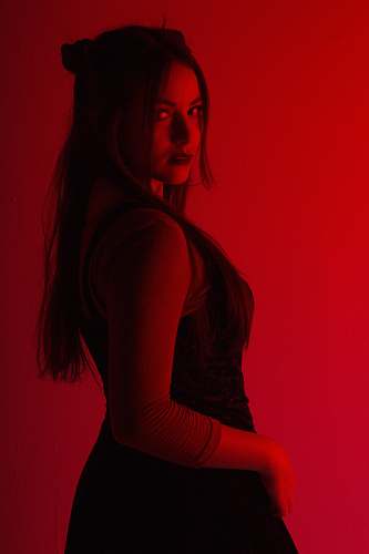 human woman in black sleeveless dress low-light photography people