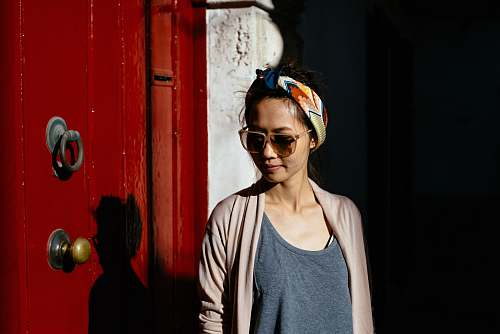 people woman in gray cardigan standing near wooden gate human
