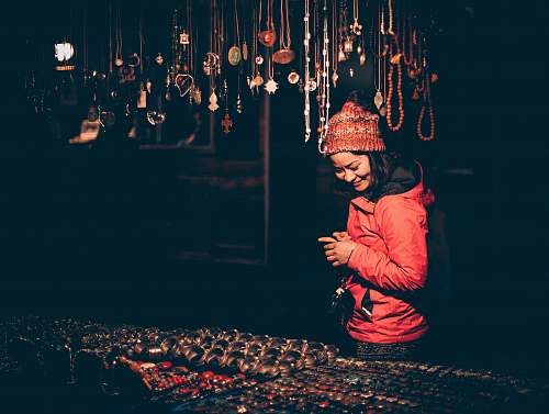 people woman looking on assorted jewelr human