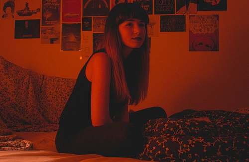 bed woman sitting on bed furniture