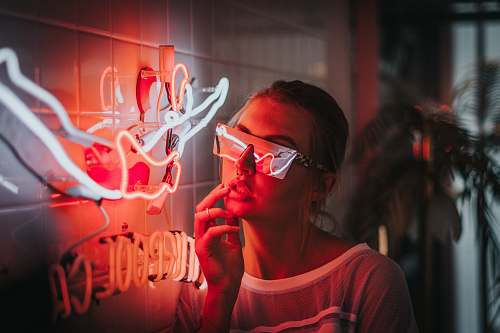 human woman standing beside lighted neon lights people