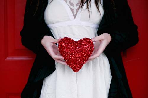 people women holding red heart pillow love