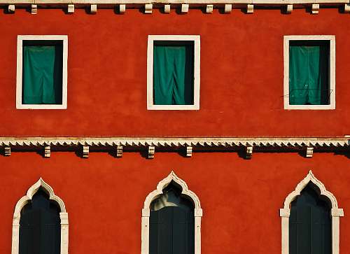 architecture close-up photography of orange concrete building arch