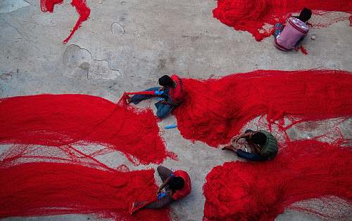 people group of people holding red nets luggage