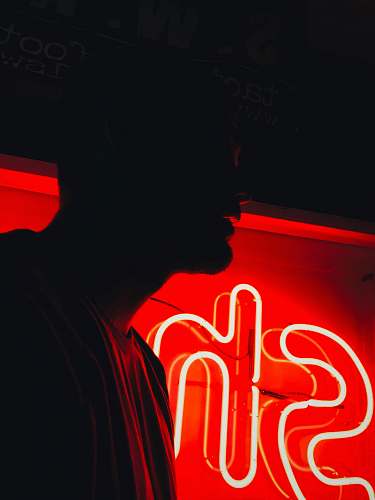 auburn man in front of red SH neon signage united states