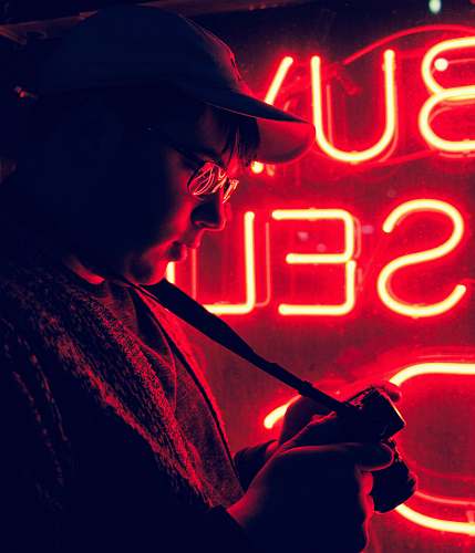 neon man standing in front of neon signage light