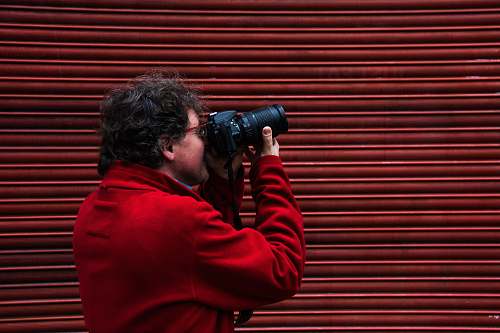 person man using black DSLR camera shoreditch
