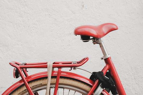 bike red bicycle near white wall bicycle