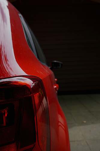 car red vehicle park in room tail light