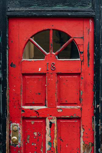 door red wooden door with brass doorknob outdoors