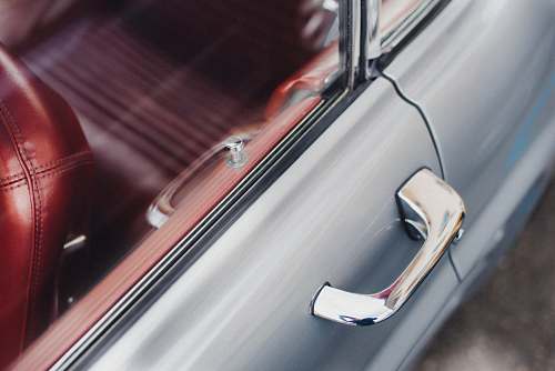 car selective focus photo of gray vehicle door handle oldschool