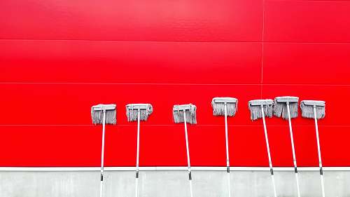 background seven white push mops on wall mop