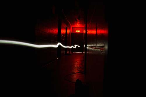 dark time lapse photography of corridor light trail