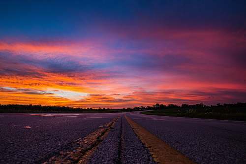 sunset road during sunset sunrise