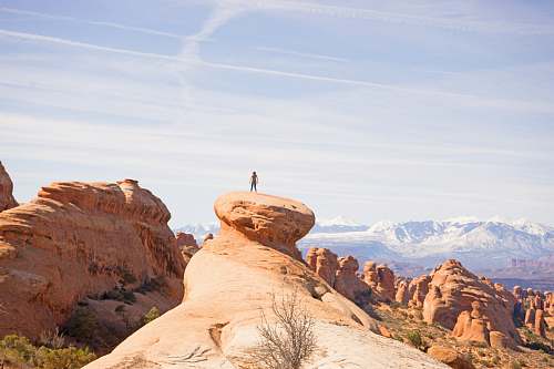 canyon person on top of canyon geological formation