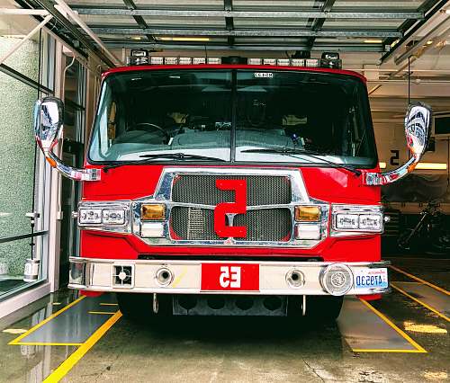 truck red and gray fire truck parked inside building fire truck
