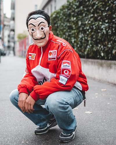 clothing selective focus photography of man wearing mask and red and white jacket apparel