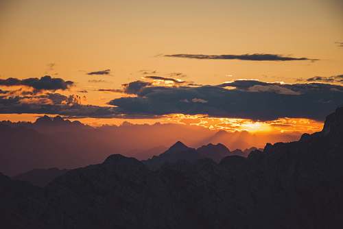 sunset aerial photography silhouette of mountains during sunset sunrise
