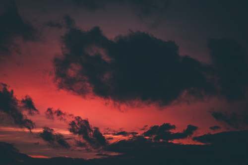 sunset selective focus photo of red sky and gray clouds dawn