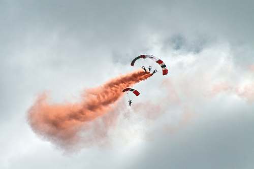 cloud worms eye view photography of people paragliding under cloudy sky parachute