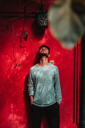 clothing shallow focus photo of man in gray crew-neck long-sleeved shirt apparel