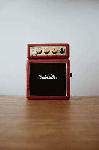 radio photo of brown Marshal guitar amplifier on brown board music