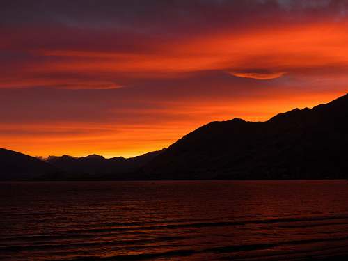 sunset body of water under sunset dawn