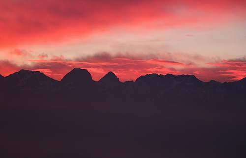 sunset silhouette of mountains during red sunset dawn