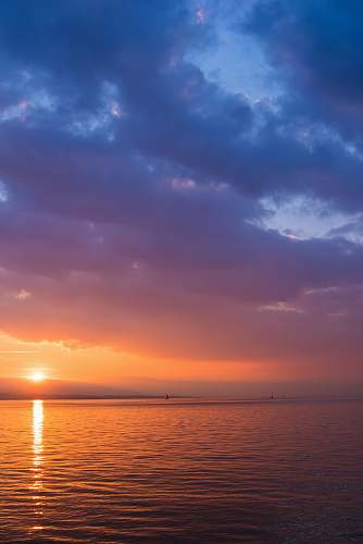 sea body of water under golden hour sky