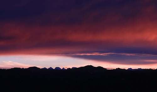 sunrise silhouette photograph of mountain ranges during golden hour nature