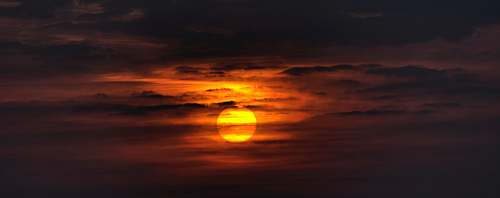 nature sunset covered by cloudy skies sun