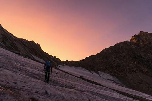 hiking person walking uphill during golden hour outdoors