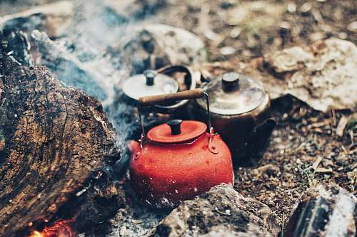 camp three red and gray kettles on charcoals tea kettle