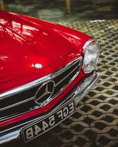 automobile shallow focus photo of red Mercedes-Benz car car