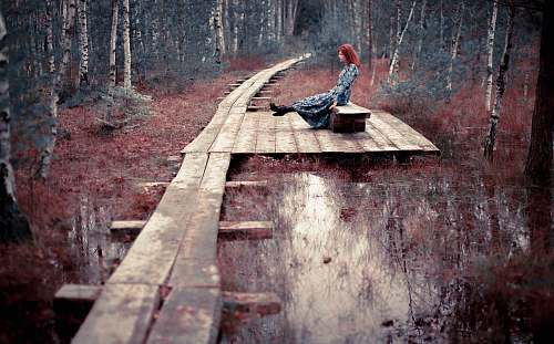 path woman seating on bench boardwalk