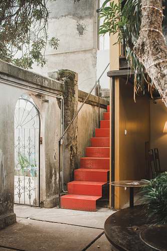 flora red metal stair beside building jar