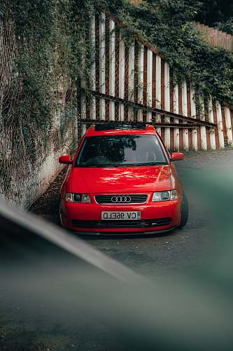 transportation red Audi vehicle on road close-up photography car