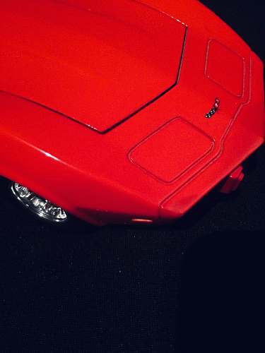 car red Corvette on black surface transportation