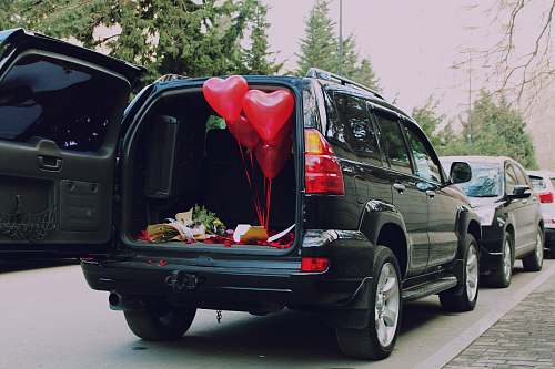 car red heart balloons inside car automobile