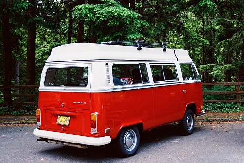 van white and red van parked near trees caravan