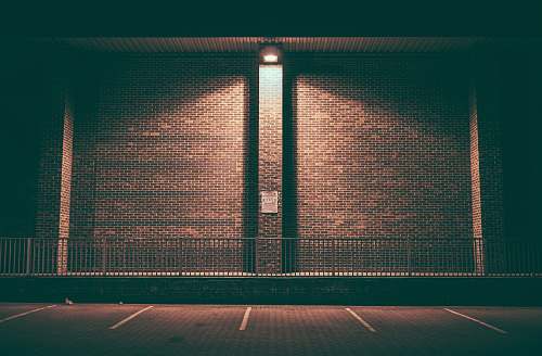 symmetrical brown concrete wall during daytime brown